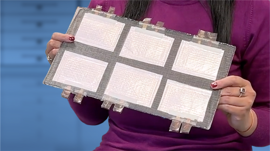 Someone holding up and showing a structural battery